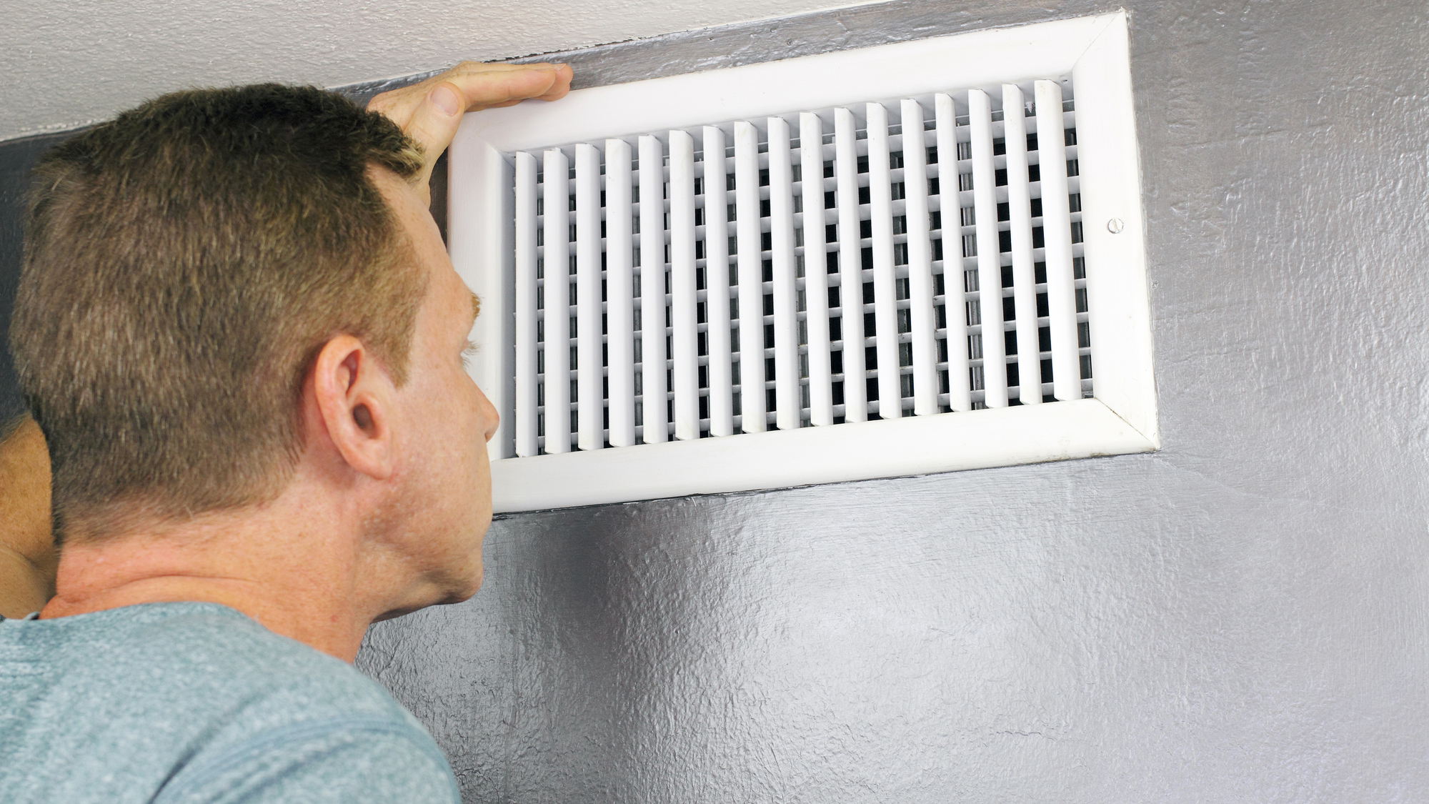 Inspecting a Home Air Vent for Maintenance