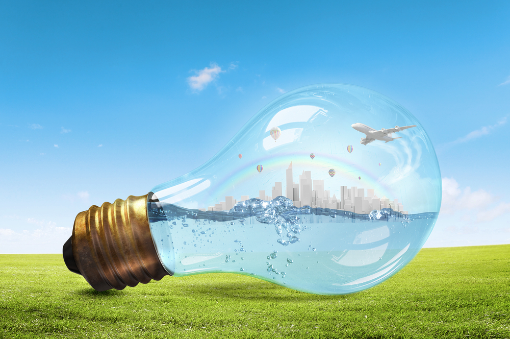 Glass light bulb with water and cityscape inside