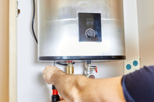 http://Plumber%20installing%20a%20tankless%20water%20heater%20inside%20a%20home