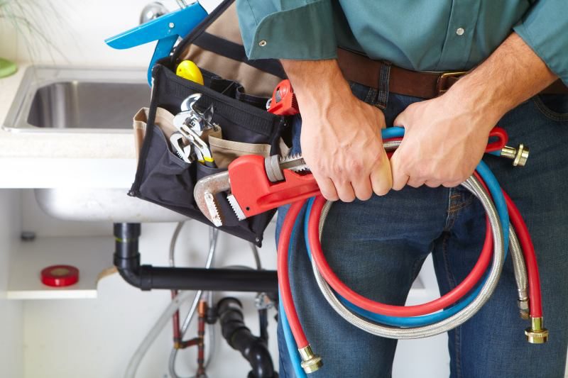 http://plumber-wearing-their-utility-belt-in-a-home-serviced-by-a-borrelli-mechanical
