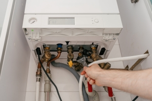 Repairman Fixing Boiler Problems for Efficient Heating