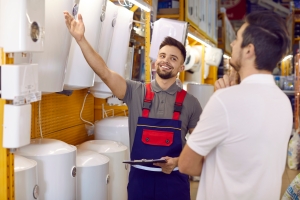 Smiling Salesman Showing Different Boilers to A Customer