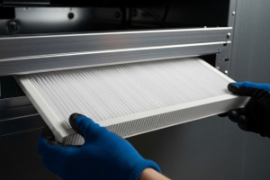 HVAC Engineer Installing New Filter to A Heating System for Performance Improvement