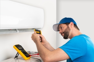HVAC Professional Tuning Up AC Unit Indoor to Reduce Cooling Bill