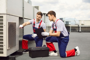 HVAC Technicians Installing Hybrid HVAC System on Building Rooftop