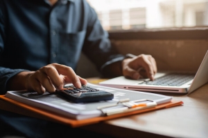 Person Calculating Sump Pump Tax Credit Before Making a Decision