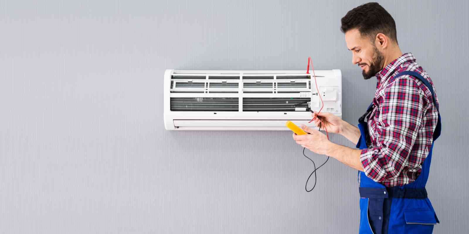 Professional HVAC Technician Testing Indoor AC Unit