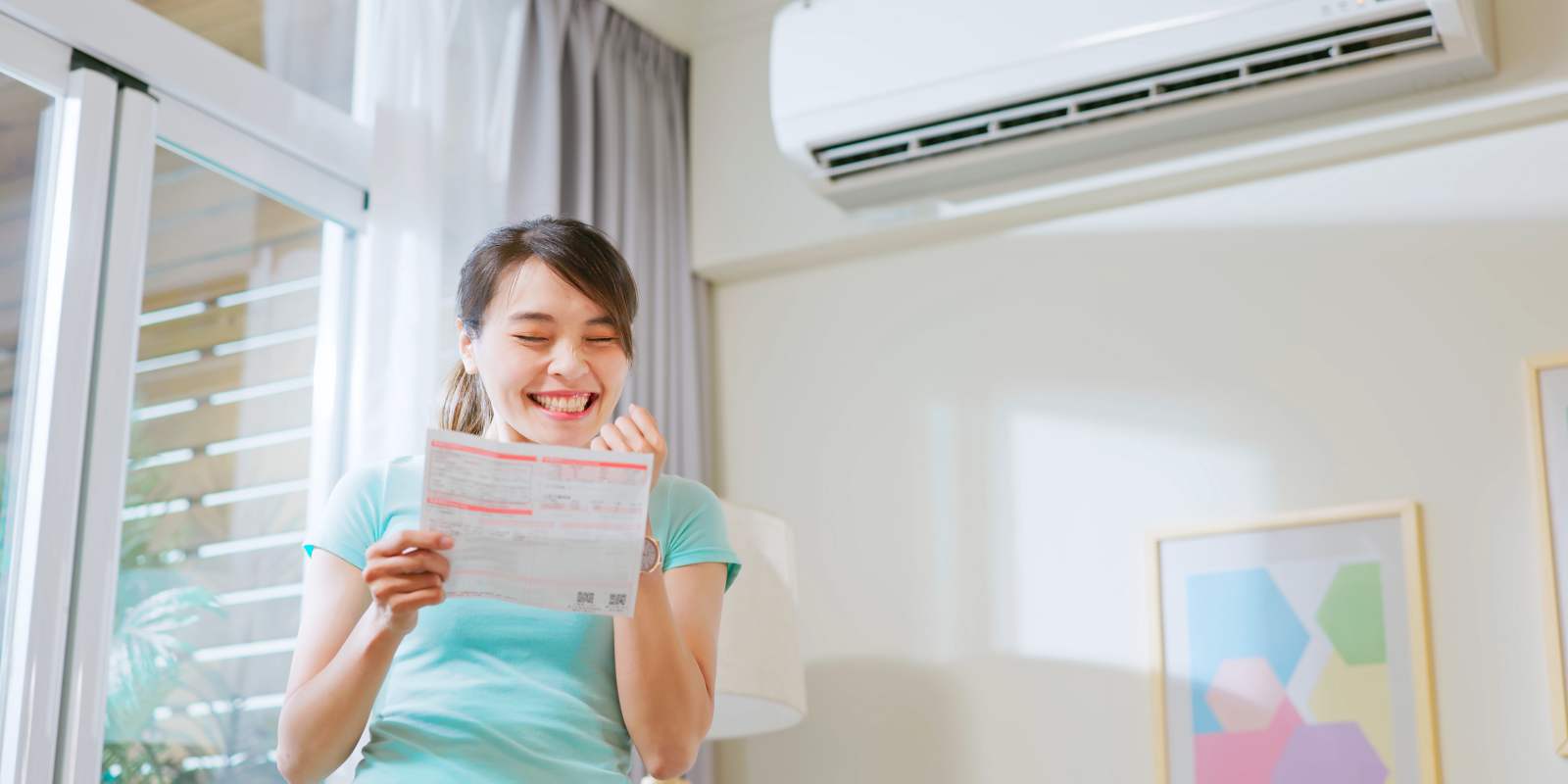 Smiling Woman Seeing Reduced Cooling Bill After AC Tune Up