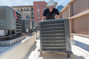 Technician Moving a New Hybrid HVAC System for Install