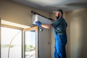 HVAC Technician Installing Ductless Mini Split AC with Level