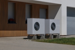 Two Electric Heat Pumps Installed Outside a Modern House