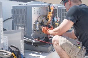 HVAC Technician Diagnosing Outdoor AC Unit to Overcome Freezing Up