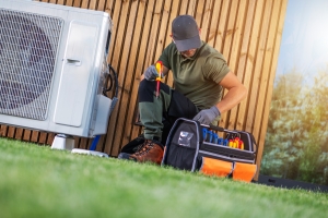 HVAC Technician Diagnosing and Repairing Heat Pump Outdoors