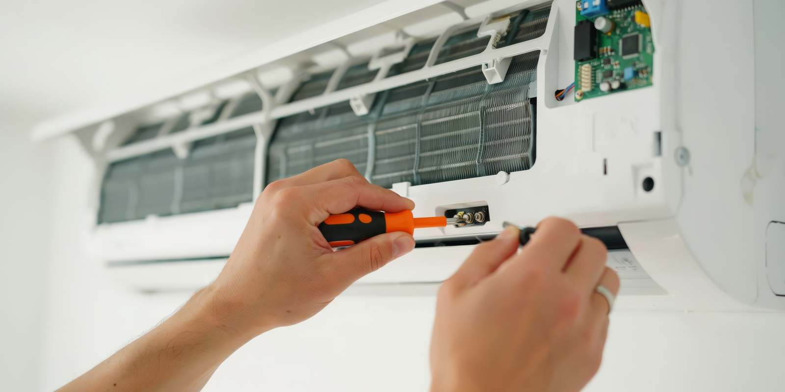 HVAC Technician Fixing AC Unit After Sudden Breakdown