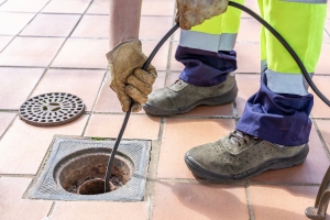 Drain Cleaning Professional Clearing Clogged Drain with Hydro Jetting Hose