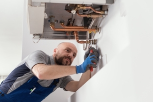 Professional Engineer Installing a Boiler in Home