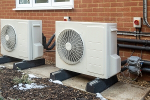 Two Heat Pump Units Installed in a Modern House Backyard